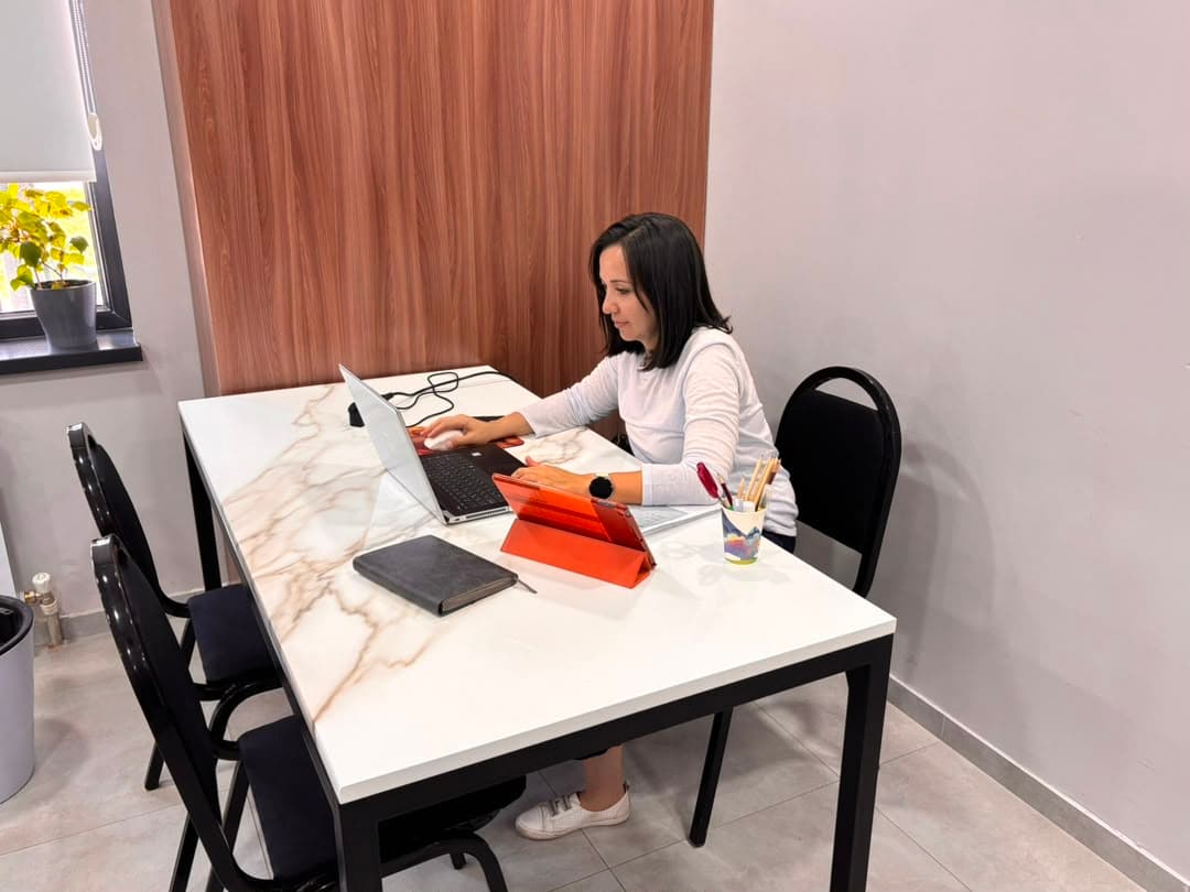 Working on a laptop in the office meeting area
