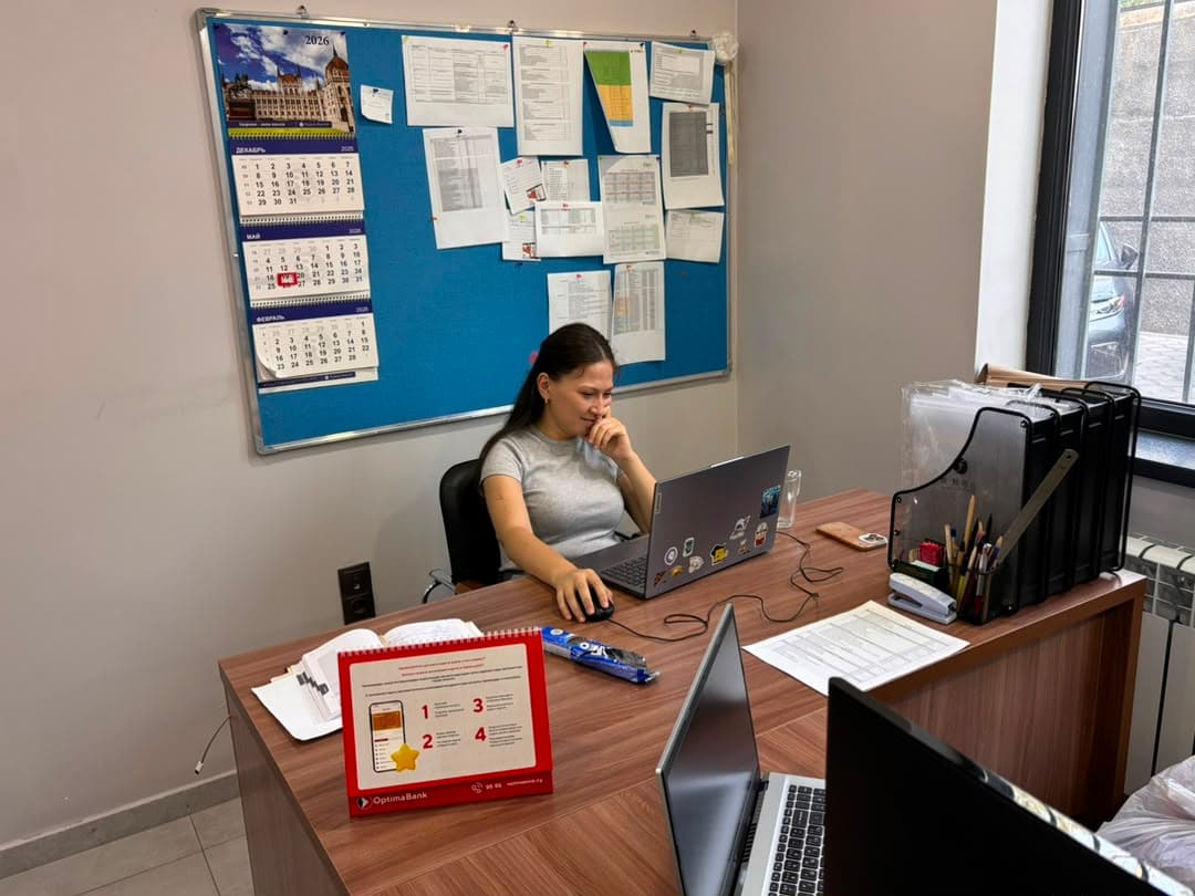 Team member at her desk with a planning board